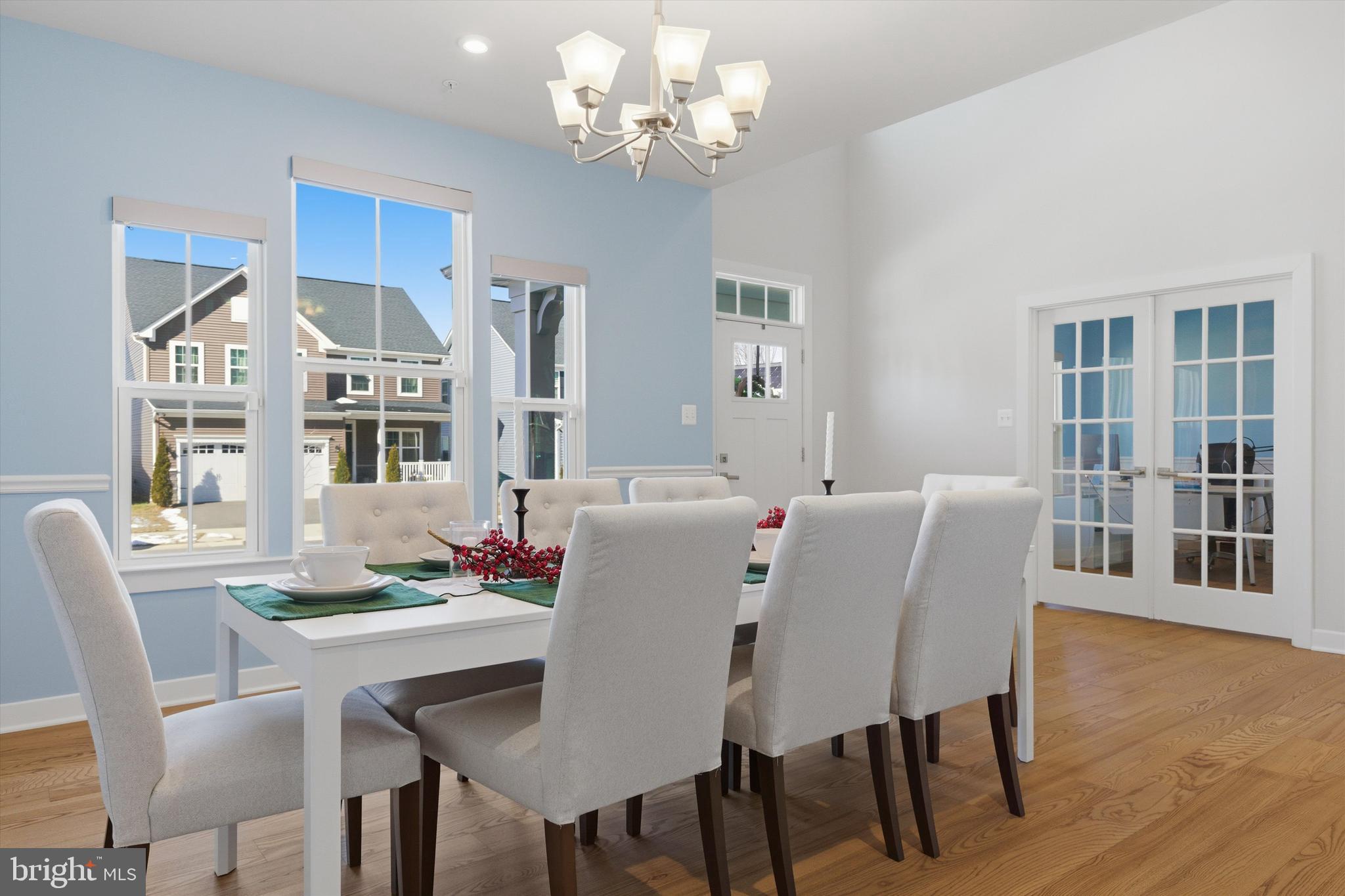 1321 Upper Patuxent Ridge Road Odenton, MD 21113 - Photo 16 of 82 a view of a dining room with furniture a chandelier and wooden floor