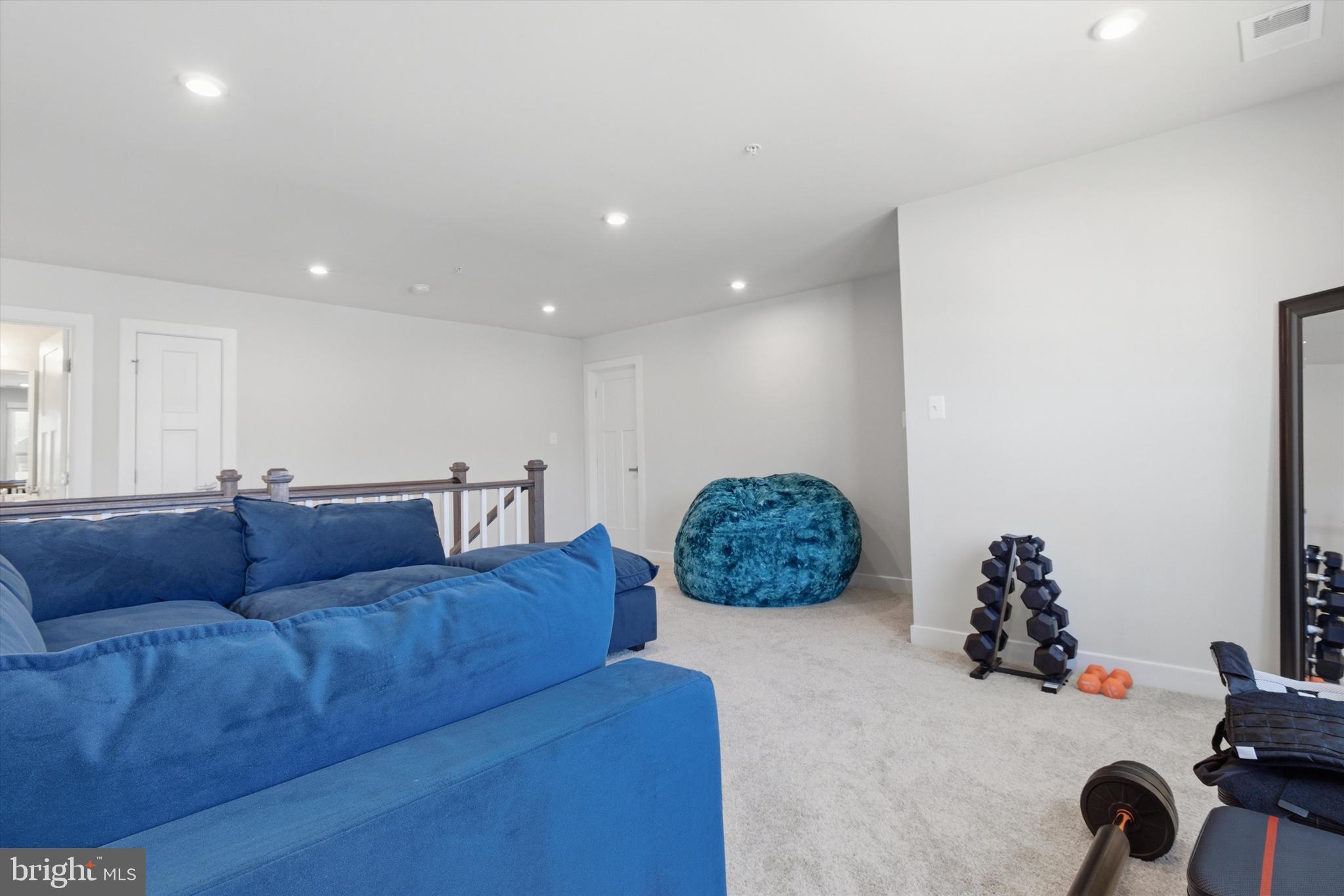 1321 Upper Patuxent Ridge Road Odenton, MD 21113 - Photo 33 of 82 a living room with furniture gym equipment and a chandelier