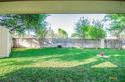 a view of a yard with an outdoor space