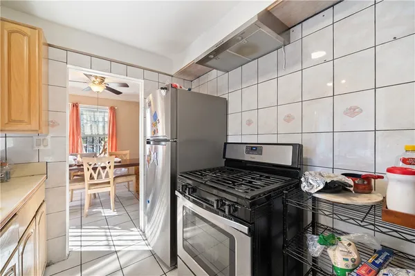 a kitchen with granite countertop a stove and a refrigerator