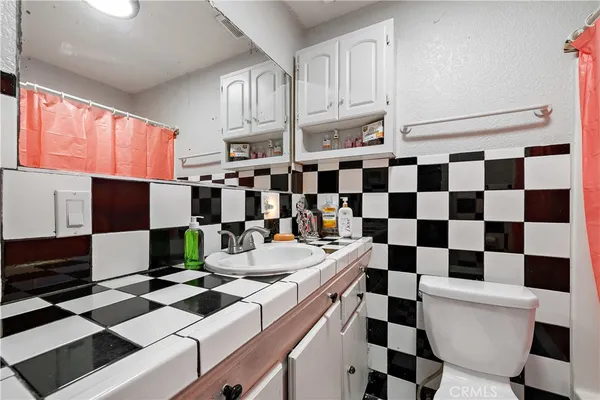 a kitchen with a sink a stove and a refrigerator