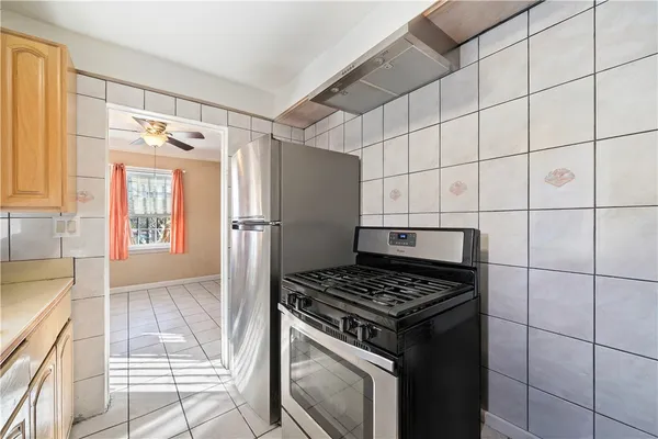 a kitchen with granite countertop a stove and a refrigerator