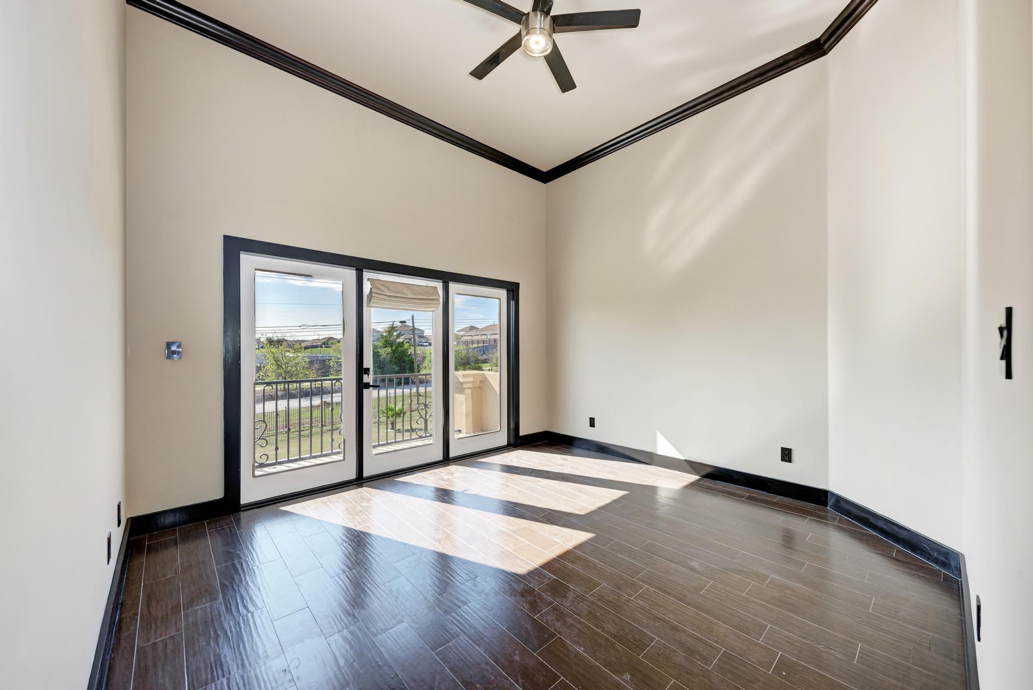 104 Spring Valley Street Hutto, TX 78634 - Photo 27 of 40 Spare room with crown molding, wood finish floors, and ceiling fan