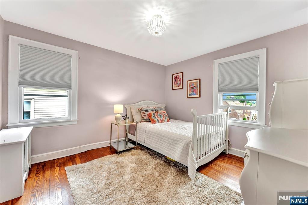57 Berkeley Avenue Belleville, NJ 07109 - Photo 18 of 36 a bedroom with a bed lamp and a window