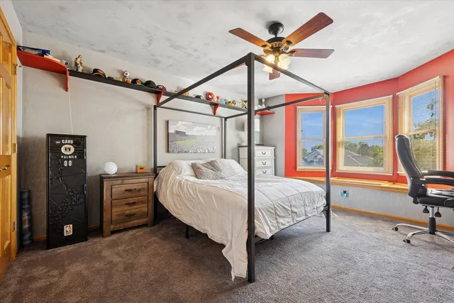 a bedroom with a bed and a large window