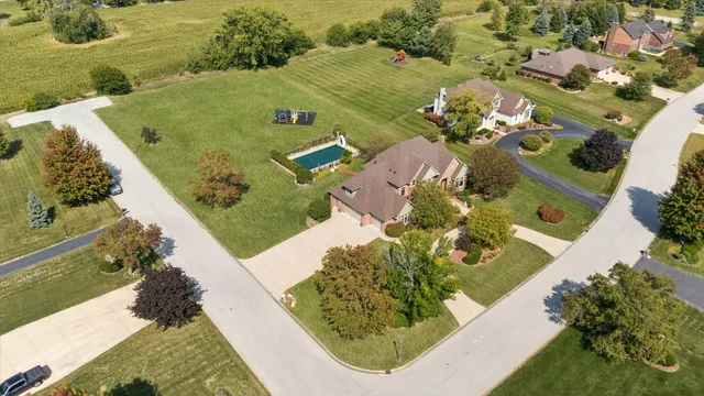 an aerial view of a house with a yard