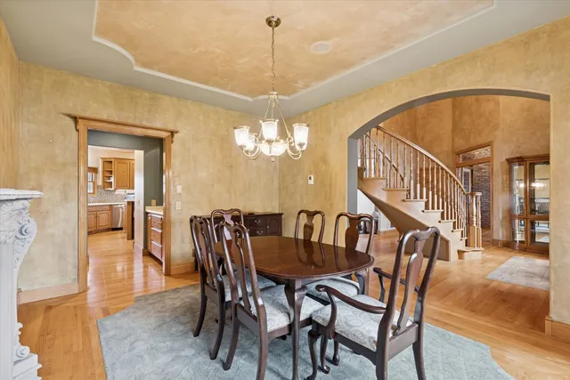 a view of a dining room with furniture and a chandelier