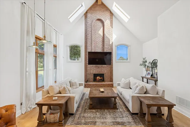 a living room with furniture fireplace and a flat screen tv