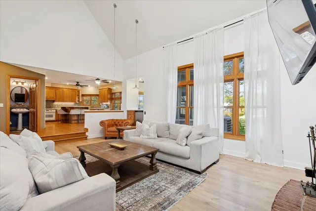 a living room with furniture wooden floor and a large window