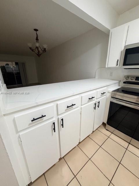 8990 Southwest 24th Street, Unit 215 Miami, FL 33165 - Photo 16 of 22 a kitchen with white cabinets and black appliances