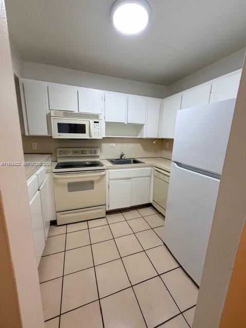 8990 Southwest 24th Street, Unit 215 Miami, FL 33165 - Photo 6 of 23 a kitchen with a stove a refrigerator and a sink