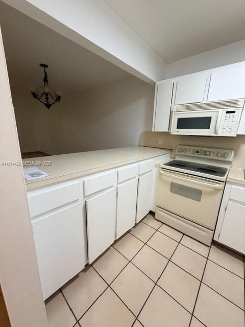 8990 Southwest 24th Street, Unit 215 Miami, FL 33165 - Photo 8 of 23 a kitchen with white cabinets appliances and sink