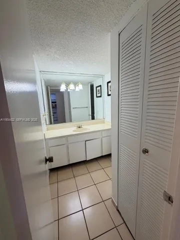 a bathroom with a sink toilet and mirror
