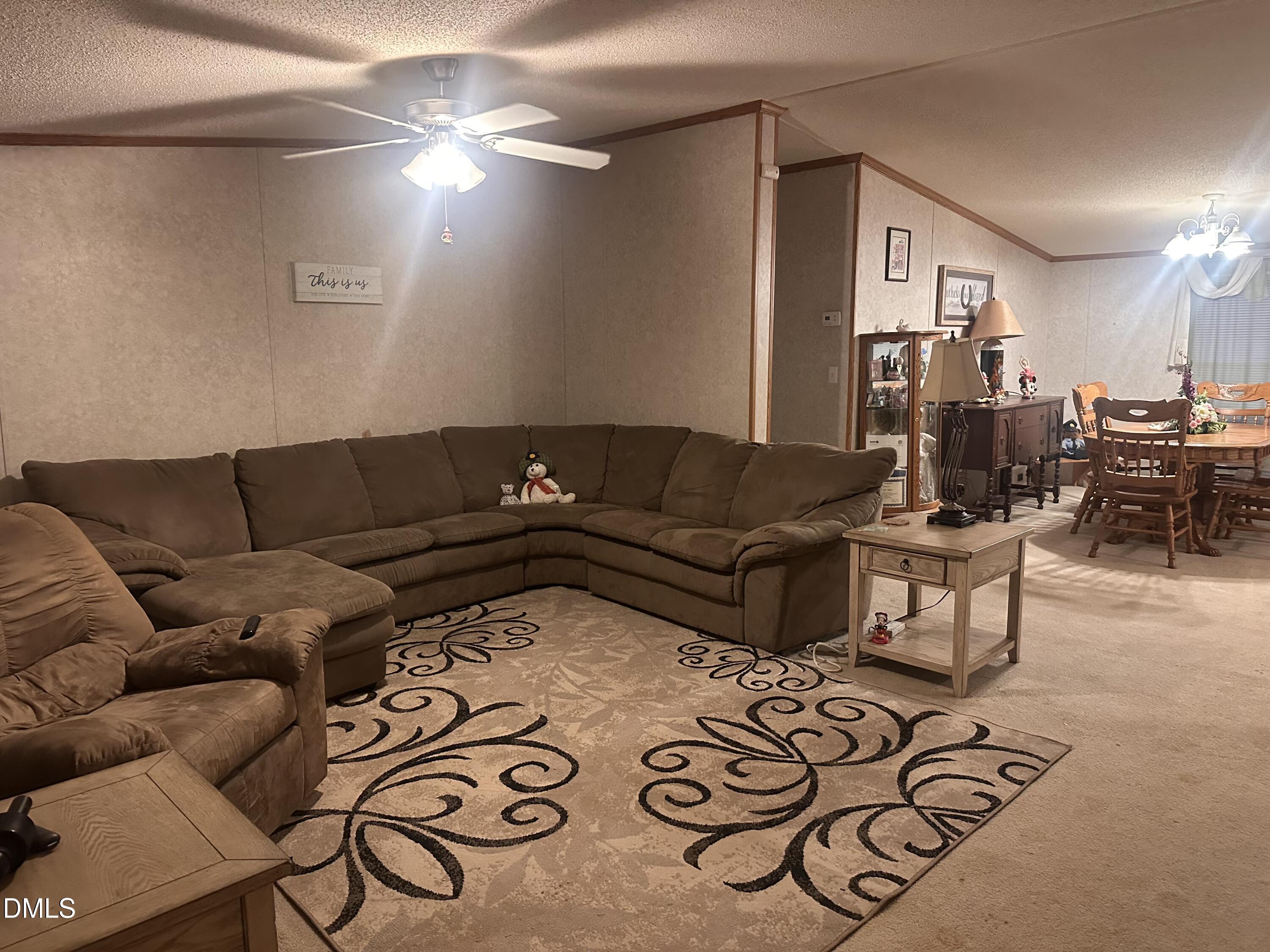 10087 Highway 39 Middlesex, NC 27557 - Photo 11 of 17 a living room with furniture and a chandelier
