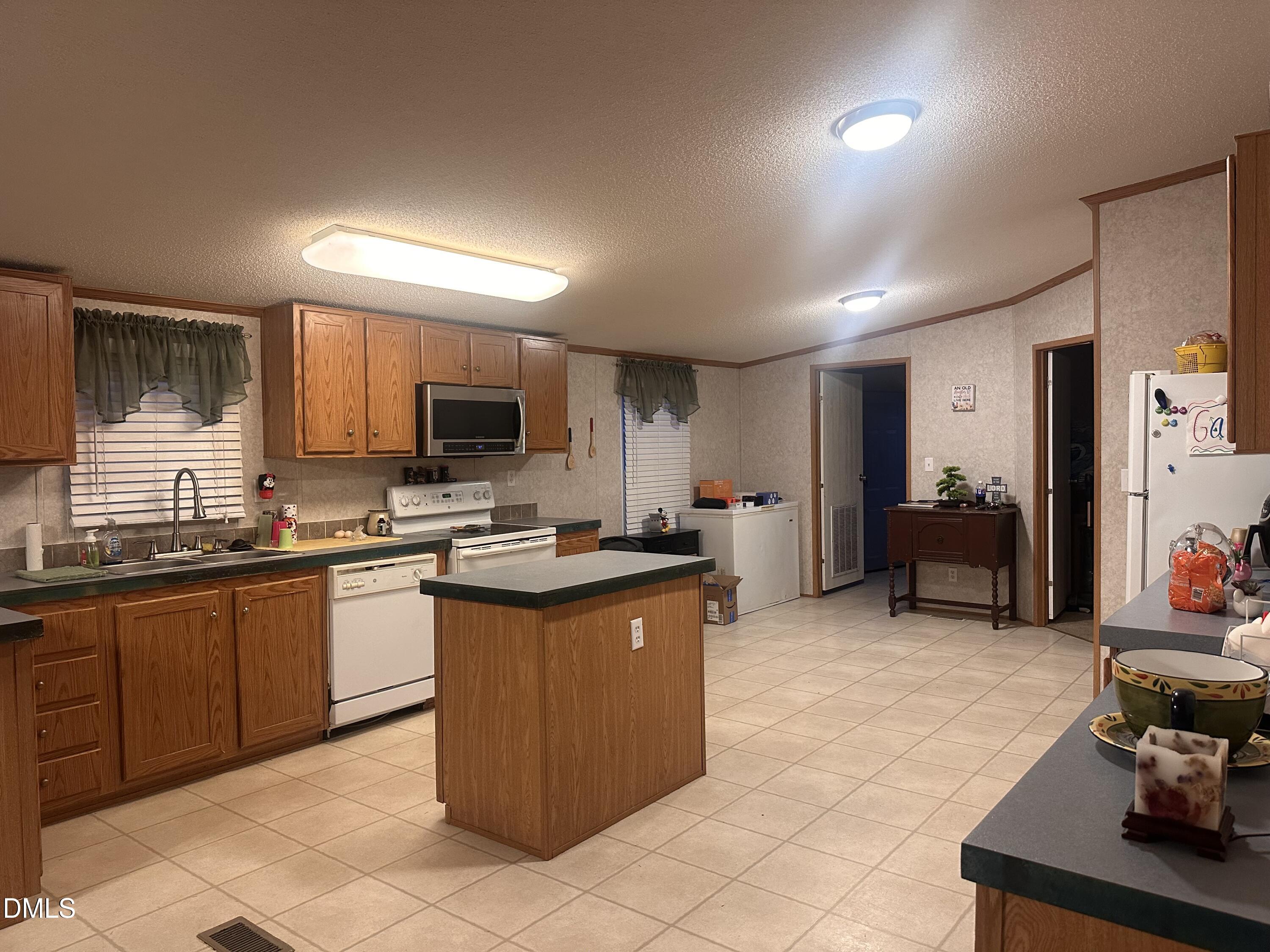 10087 Highway 39 Middlesex, NC 27557 - Photo 14 of 17 a large kitchen with stainless steel appliances granite countertop a sink and cabinets