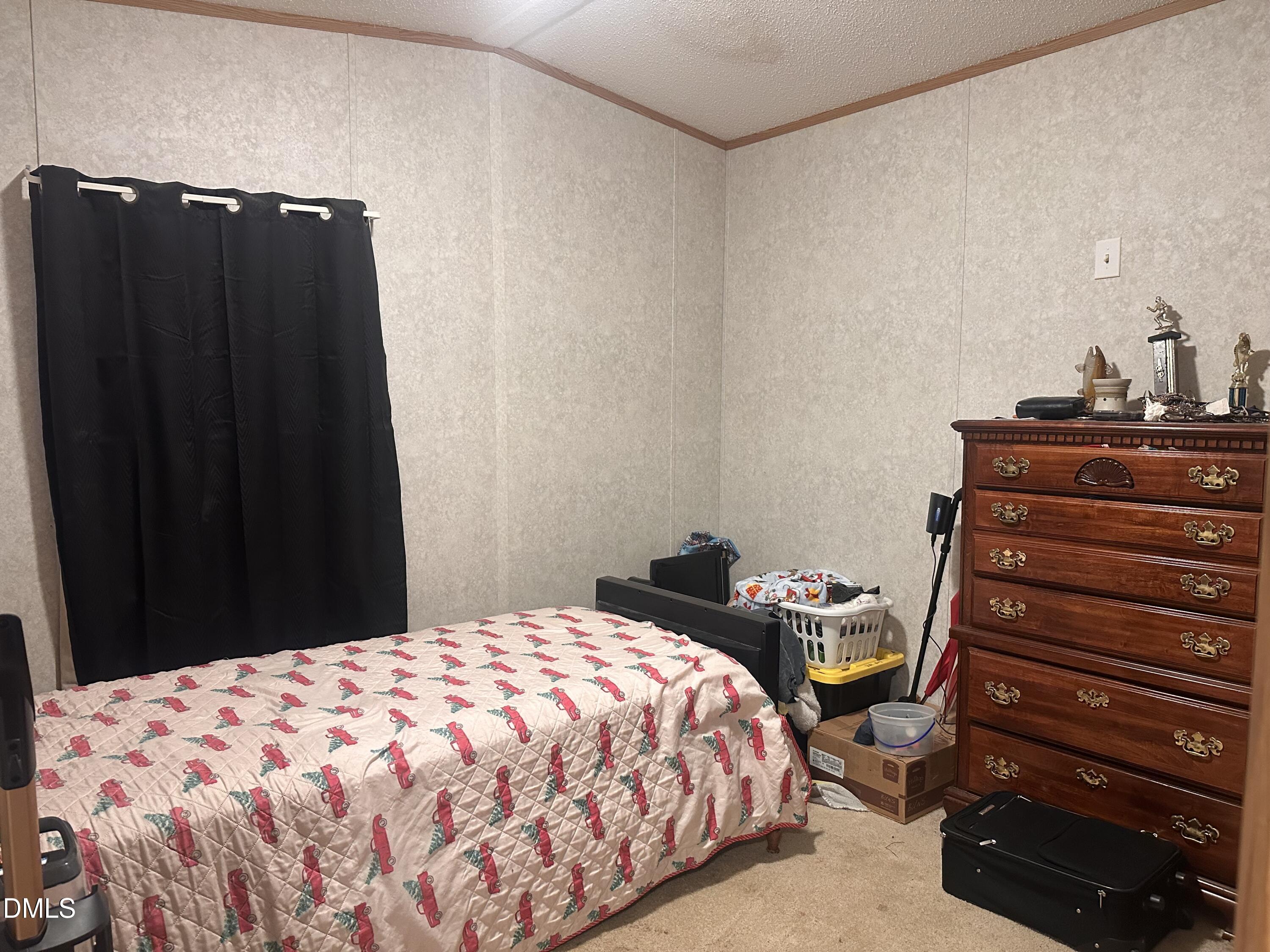 10087 Highway 39 Middlesex, NC 27557 - Photo 16 of 17 a bedroom with a bed and a dresser