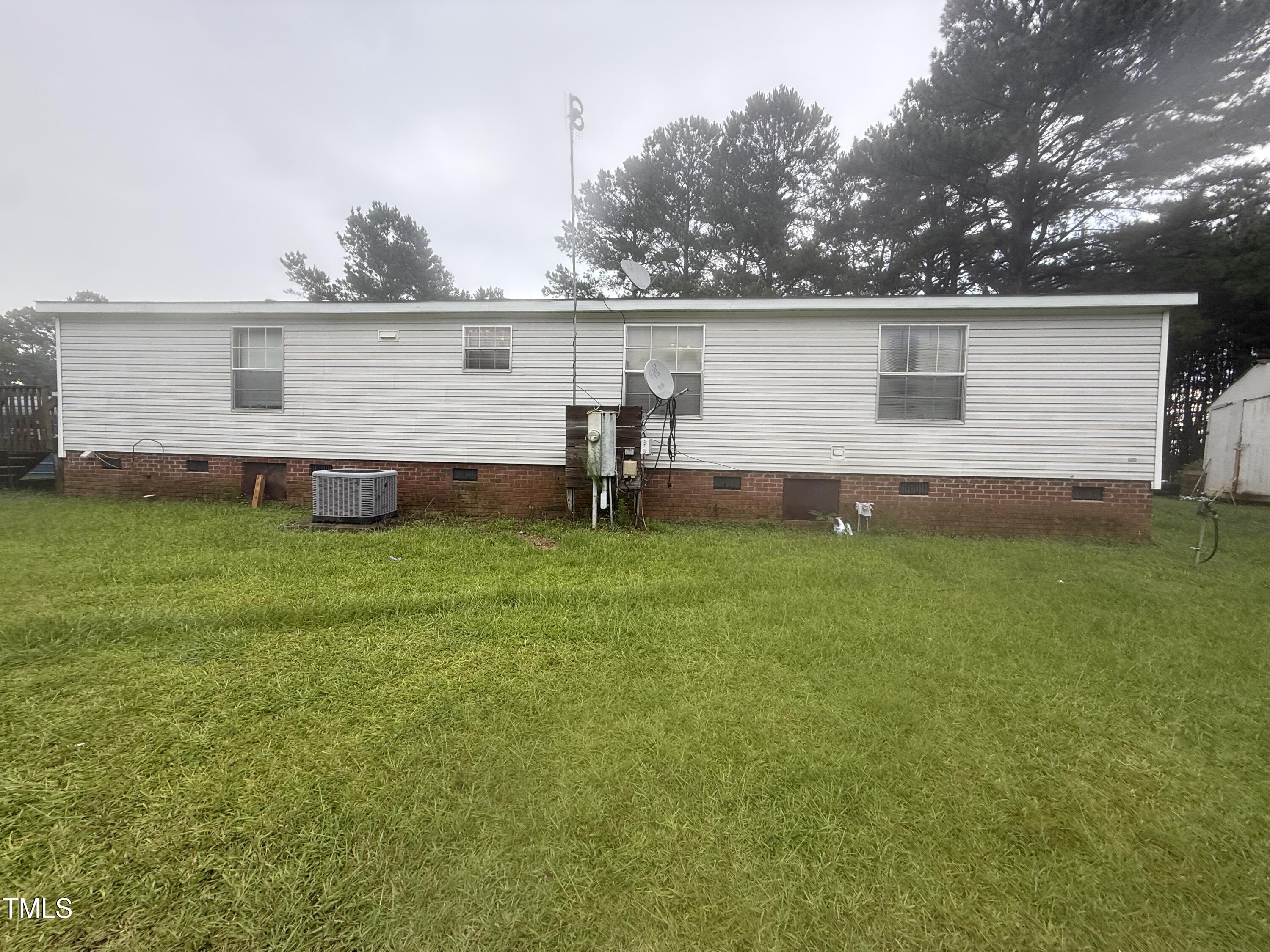 10087 Highway 39 Middlesex, NC 27557 - Photo 3 of 17 a view of a house with a yard and sitting area