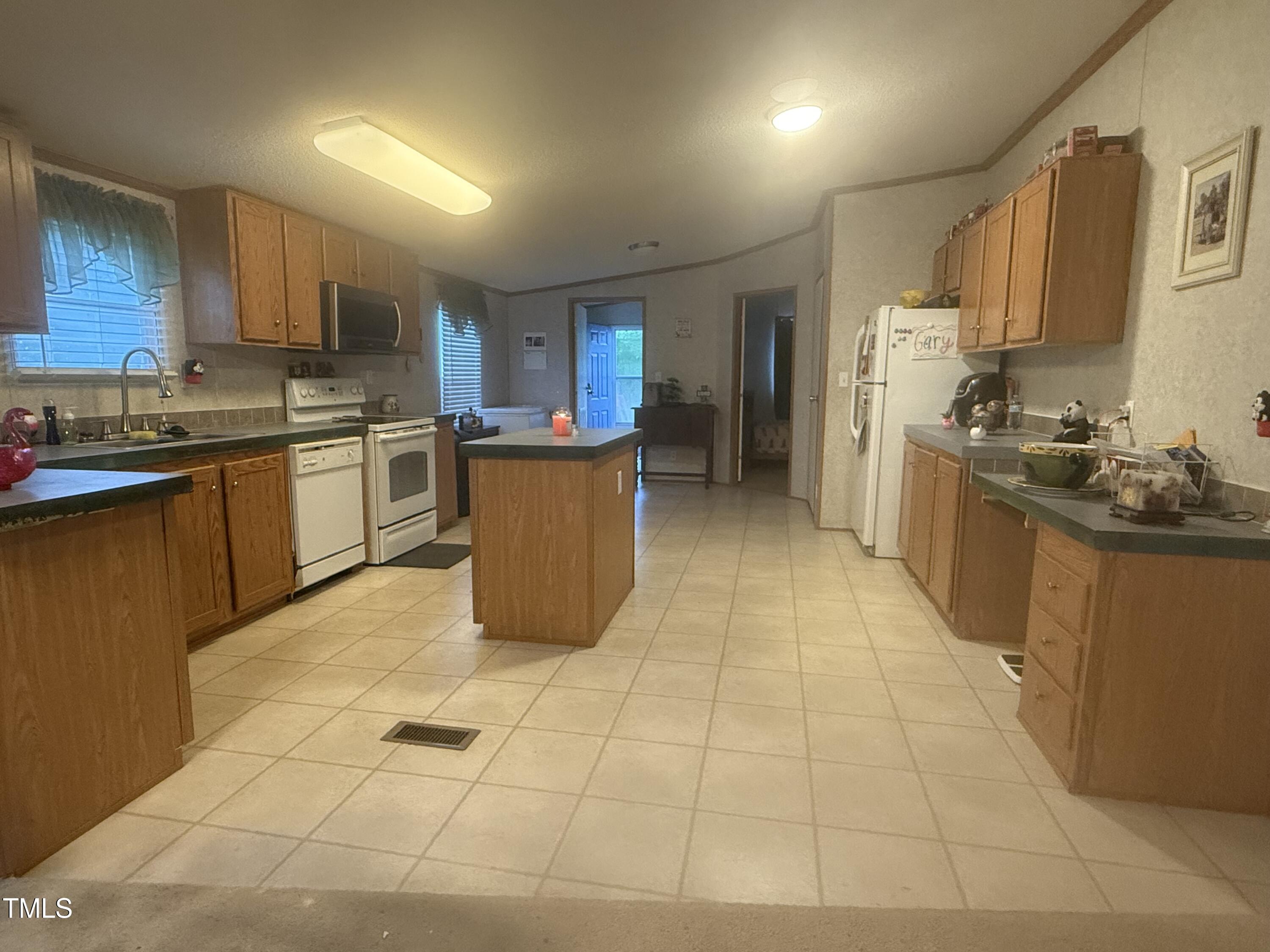 10087 Highway 39 Middlesex, NC 27557 - Photo 4 of 17 a kitchen with stainless steel appliances granite countertop a sink counter space cabinets and a stove
