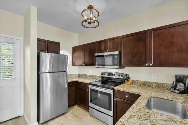 a kitchen with a refrigerator stove and microwave