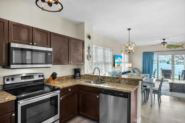 a view of living room with granite countertop furniture and a chandelier