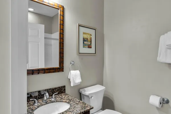 a living room with furniture a large window and a dining table