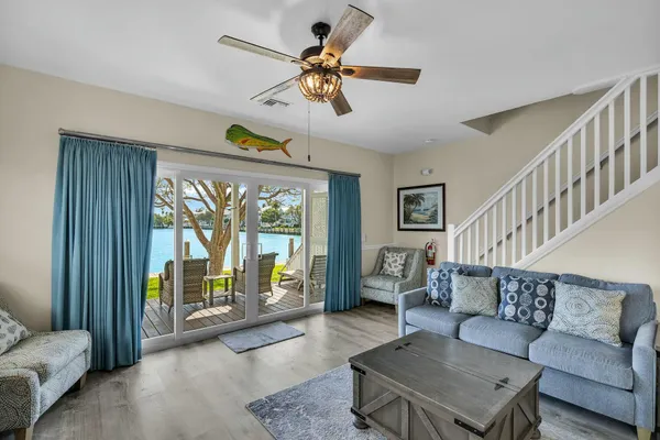 a living room with furniture and large windows