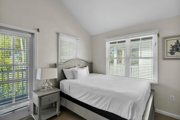 a bedroom with a bed a table and a window