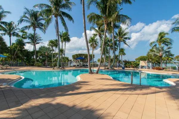 a swimming pool with outdoor seating and yard