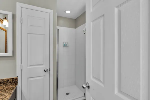 a living room with furniture kitchen view and a wooden floor