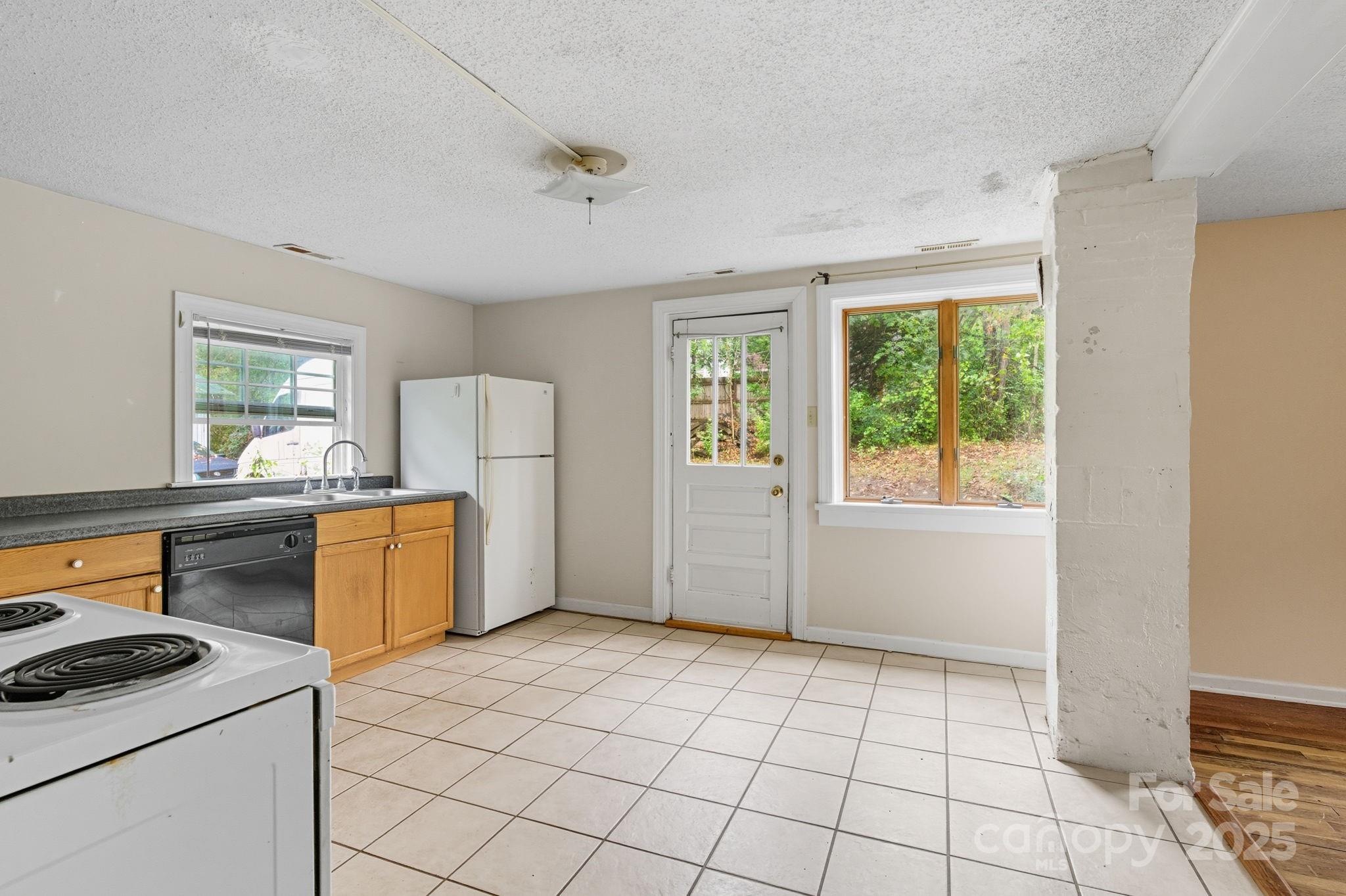 132 Little Knob Road Asheville, NC 28803 - Photo 9 of 18 a kitchen with a stove a refrigerator and a sink