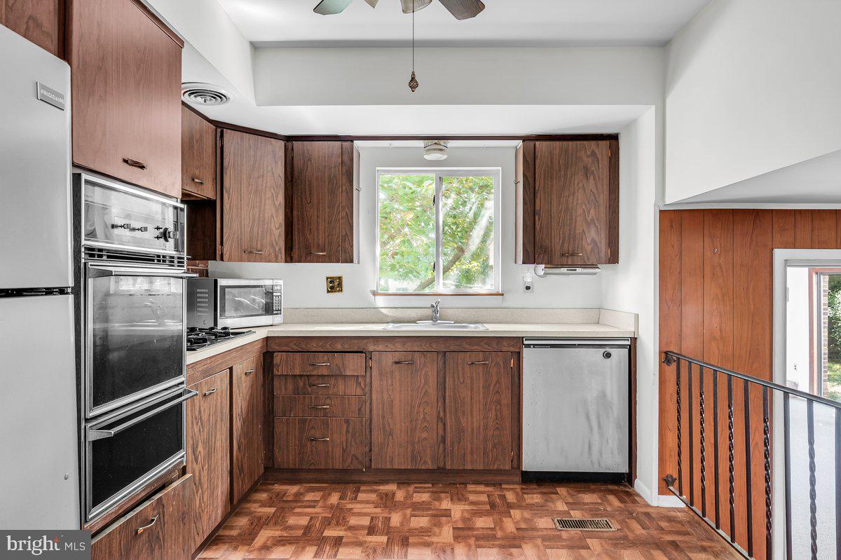 1216 Grayrock Road Newark, DE 19713 - Photo 11 of 28 a kitchen with stainless steel appliances granite countertop a sink stove and refrigerator