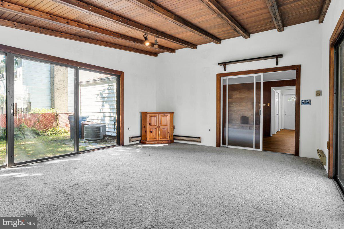 1216 Grayrock Road Newark, DE 19713 - Photo 15 of 28 an empty room with sliding door and wooden floor