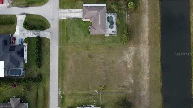an aerial view of residential house with outdoor space and parking