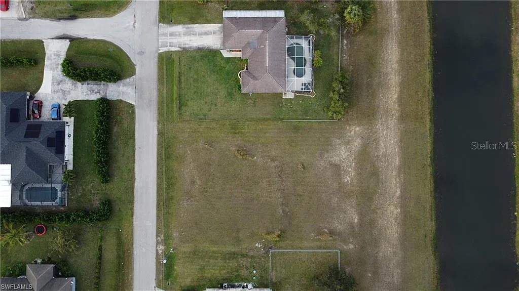 2702 Rita Avenue North Lehigh Acres, FL 33971 - Photo 2 of 4 an aerial view of residential house with outdoor space and parking