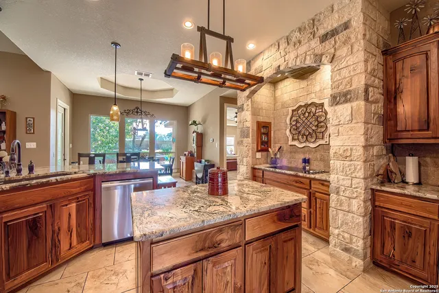 a kitchen with stainless steel appliances granite countertop a sink and cabinets