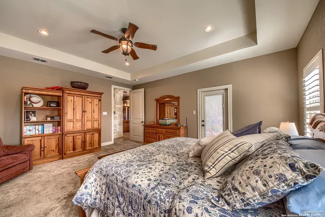 a bedroom with a large bed and a chandelier