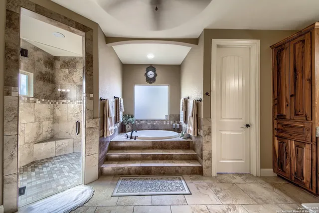 a view of a bathroom with mirror and shower