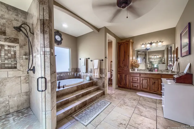 a spacious bathroom with a tub and shower