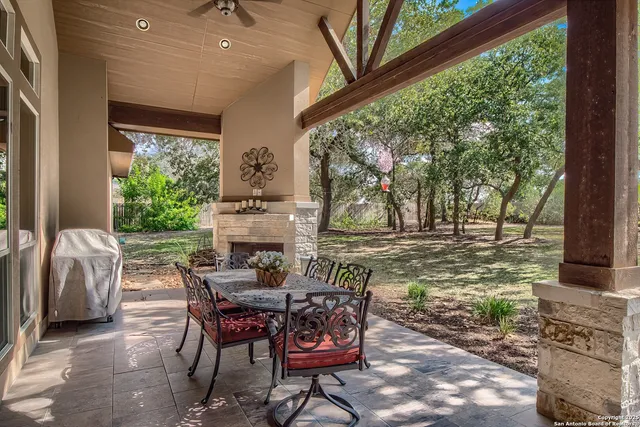 a view of a patio with table and chairs and potted plants