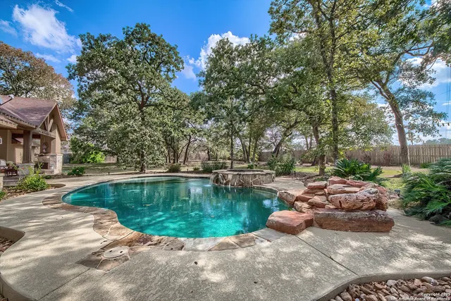 a view of a swimming pool with sitting area
