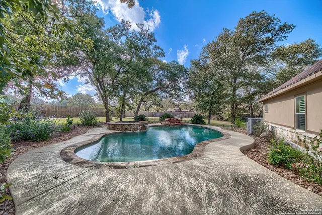 a view of a backyard with swimming pool