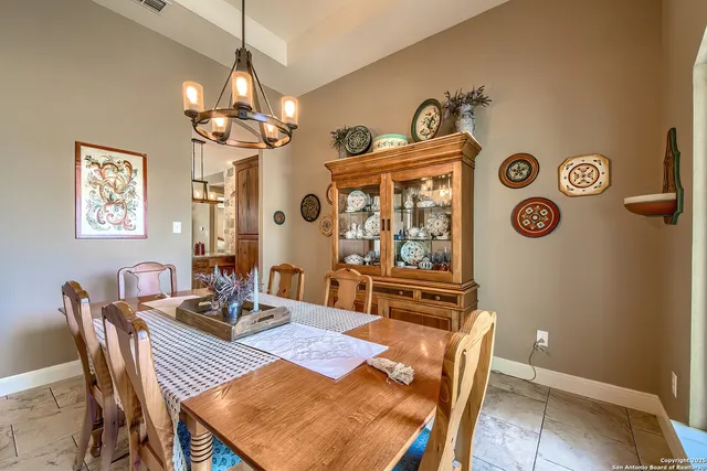 a view of a dining room with furniture and chandelier