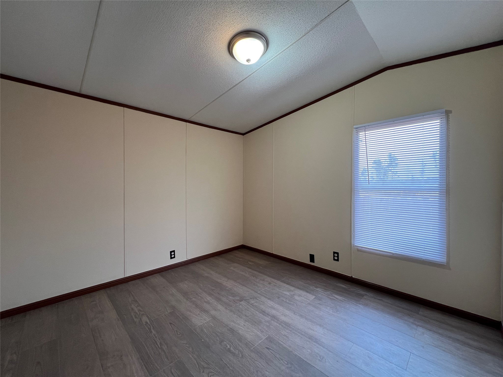 568 5914-10 Road Cleveland, TX 77327 - Photo 10 of 11 an empty room with wooden floor and windows