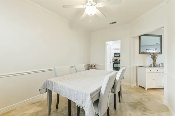 an empty room with a ceiling fan and a window