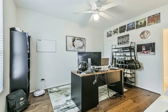 an empty room with a ceiling fan and a window