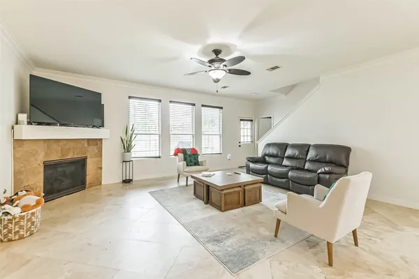a living room with furniture fireplace and window