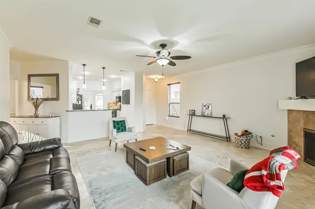 a kitchen with stainless steel appliances kitchen island granite countertop a refrigerator and a stove top oven