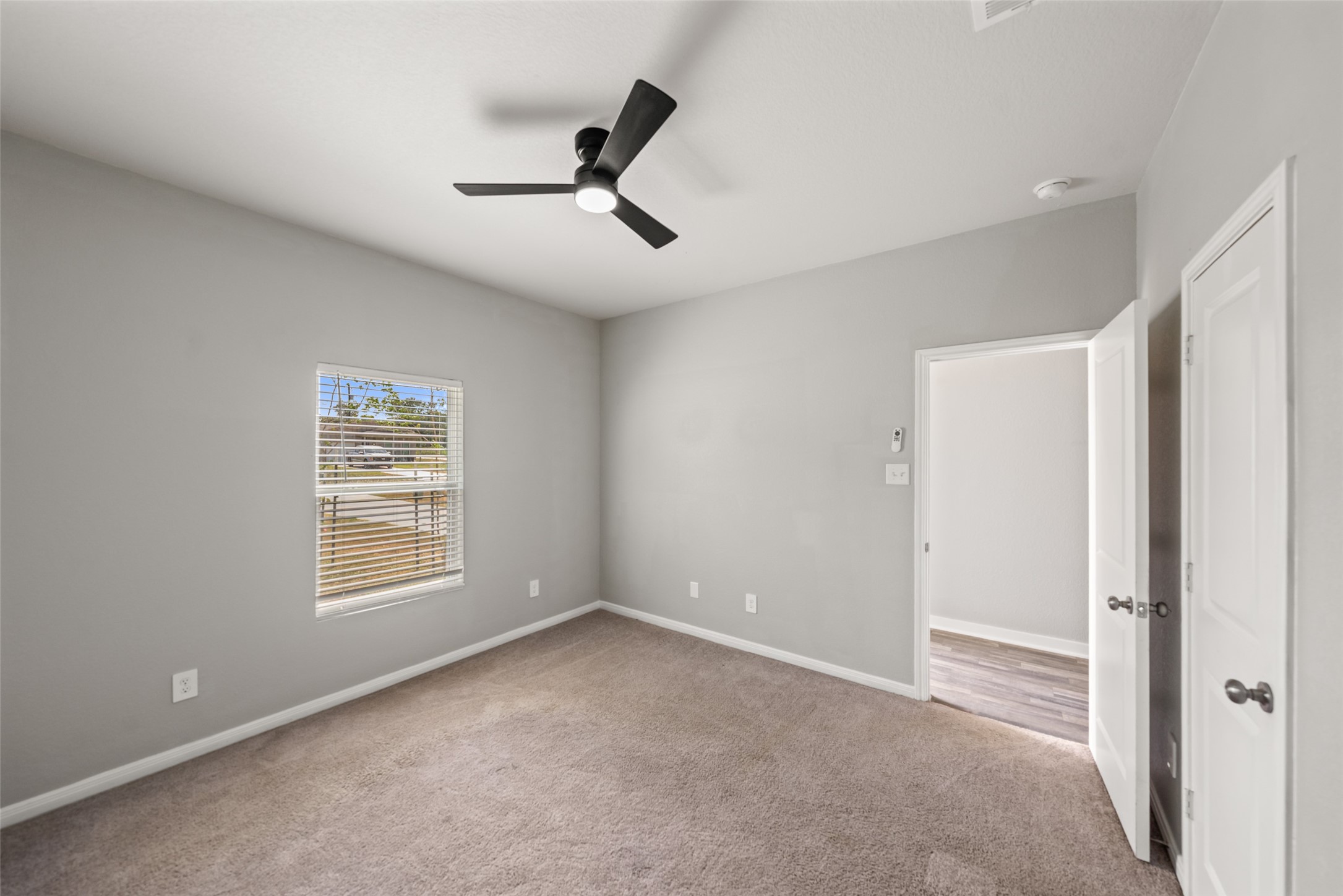 2537 18th Street Hempstead, TX 77445 - Photo 21 of 28 Additional bedroom view showcasing the ceiling fan, carpet flooring, and comfortable room dimensions.