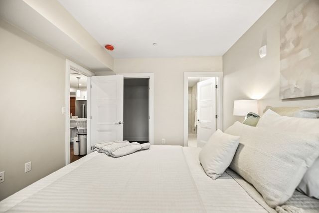 a bedroom with a bed and a large mirror