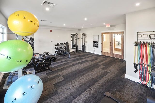 a room with gym equipment and mirror